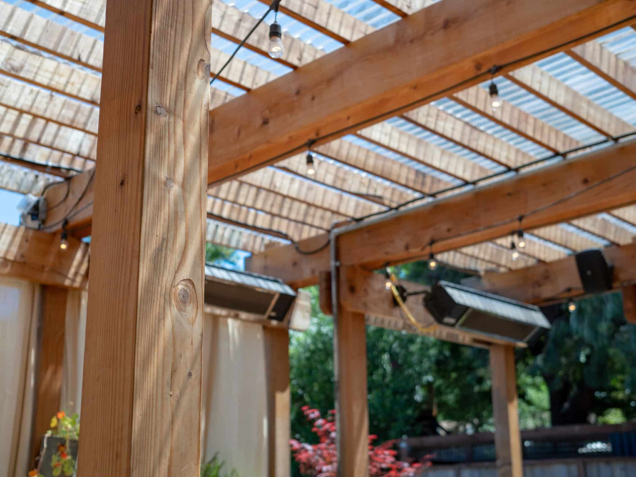 Outdoor restaurant set up with patio and wooden overhang and speakers