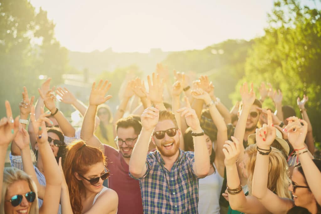 Group of people dancing and having a good time at the outdoor party/music festival